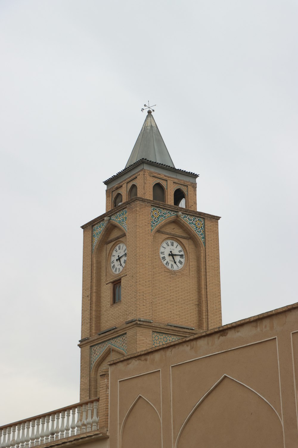 a tall clock tower with a clock on each of it's sides