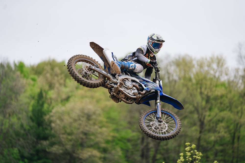 a man riding a dirt bike through the air