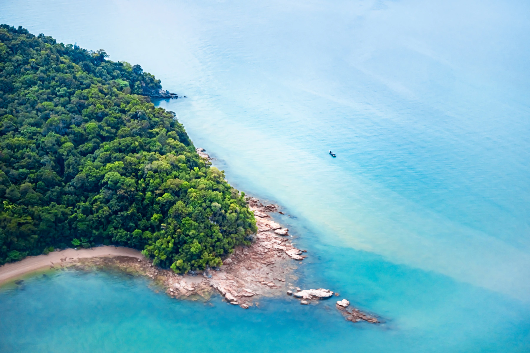 Aerial view of a lush tropical island and turquoise sea in Langkawi, Malaysia