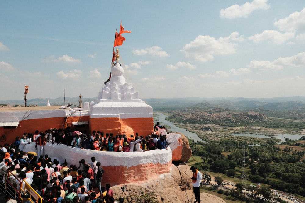 a crowd of people standing on top of a hill