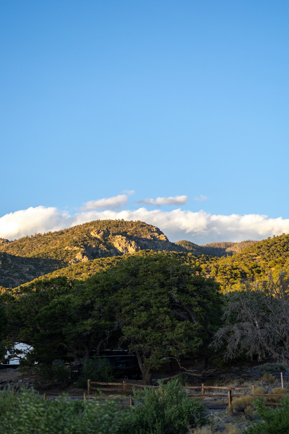 a view of a mountain with clouds in the sky