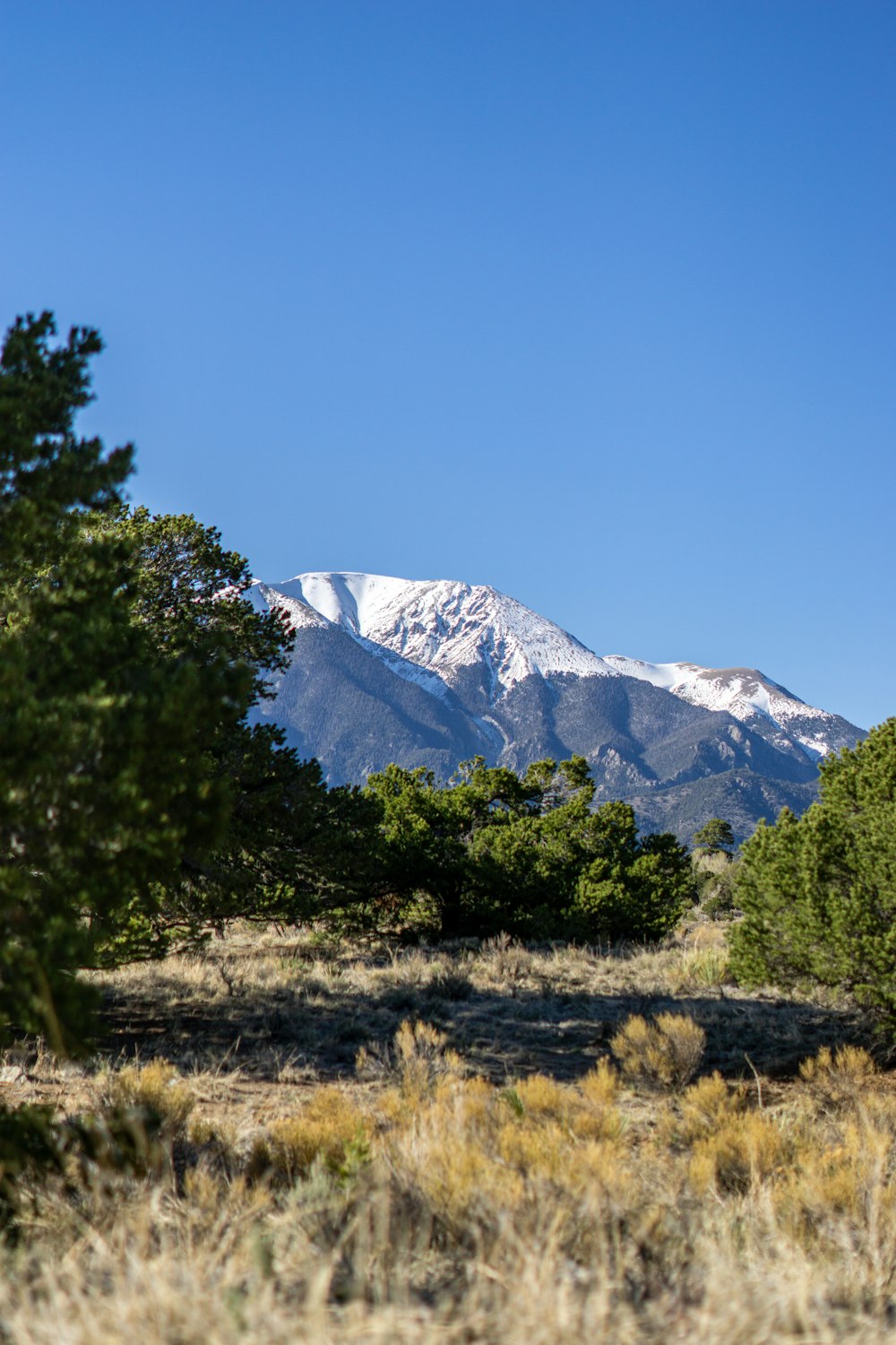 a view of a snow covered mountain in the distance