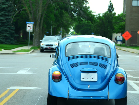 a blue car parked on the side of the road