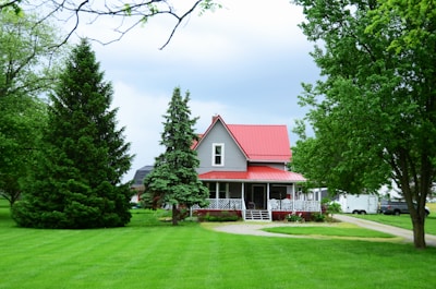 a house with a red roof surrounded by trees