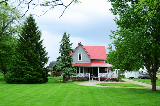 a house with a red roof surrounded by trees