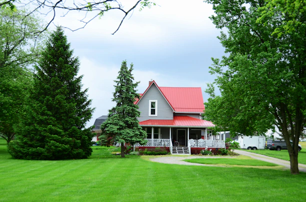 a house with a red roof surrounded by trees