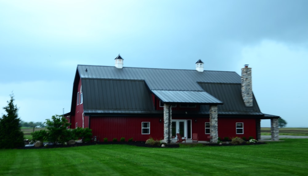 a large red barn with a black roof