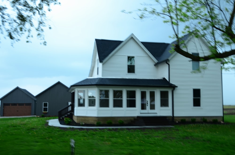 a large white house with a black roof