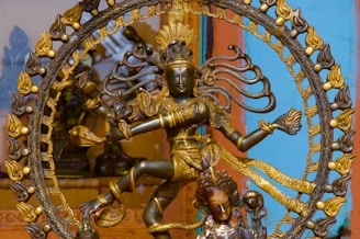 a statue of a woman dancing in front of a clock