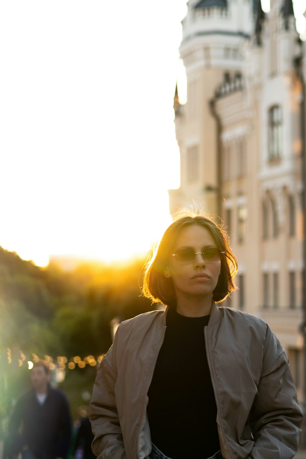 a woman standing in front of a large building