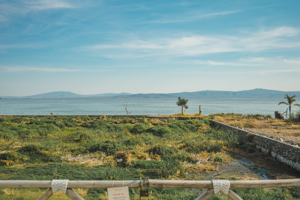 a view of a body of water from behind a fence