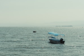 a small boat floating on top of a large body of water