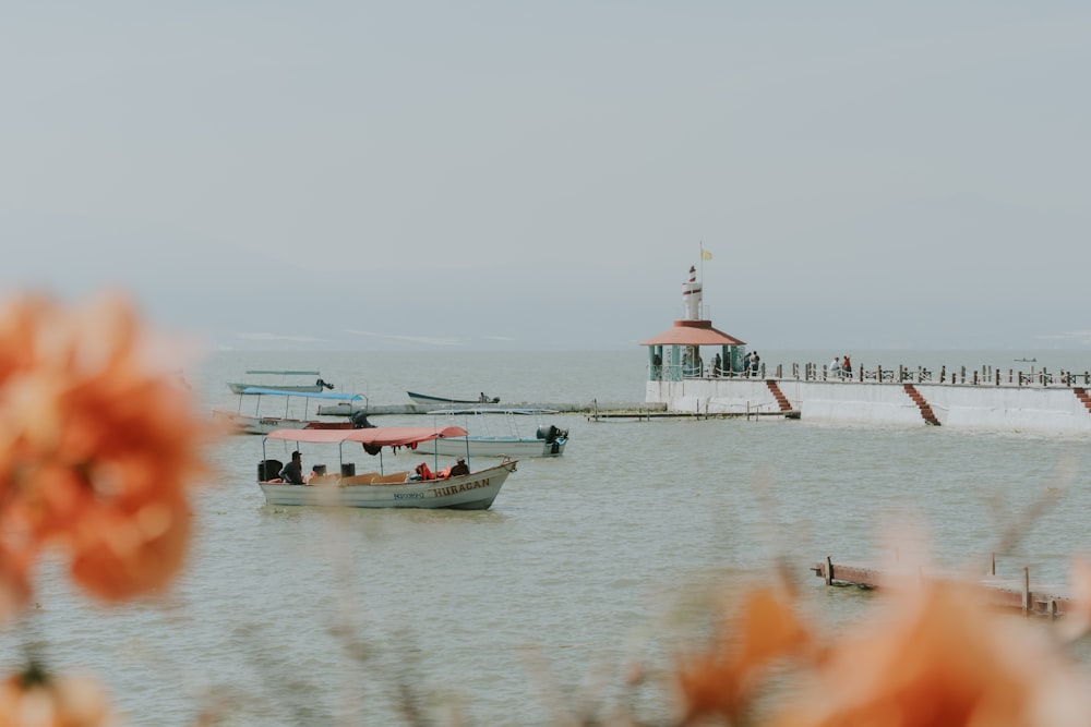 a group of boats floating on top of a body of water