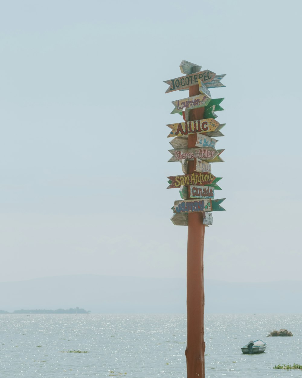 a pole with a bunch of signs on top of it