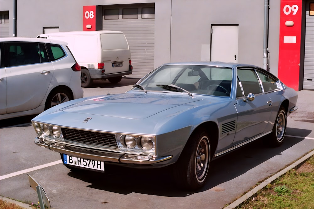 a car parked in a parking lot next to a building