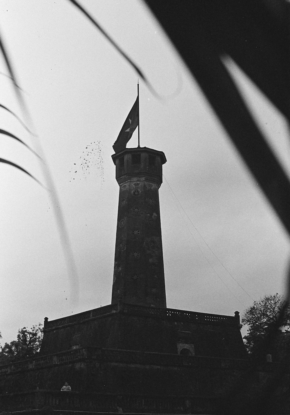 a tall tower with a flag on top of it