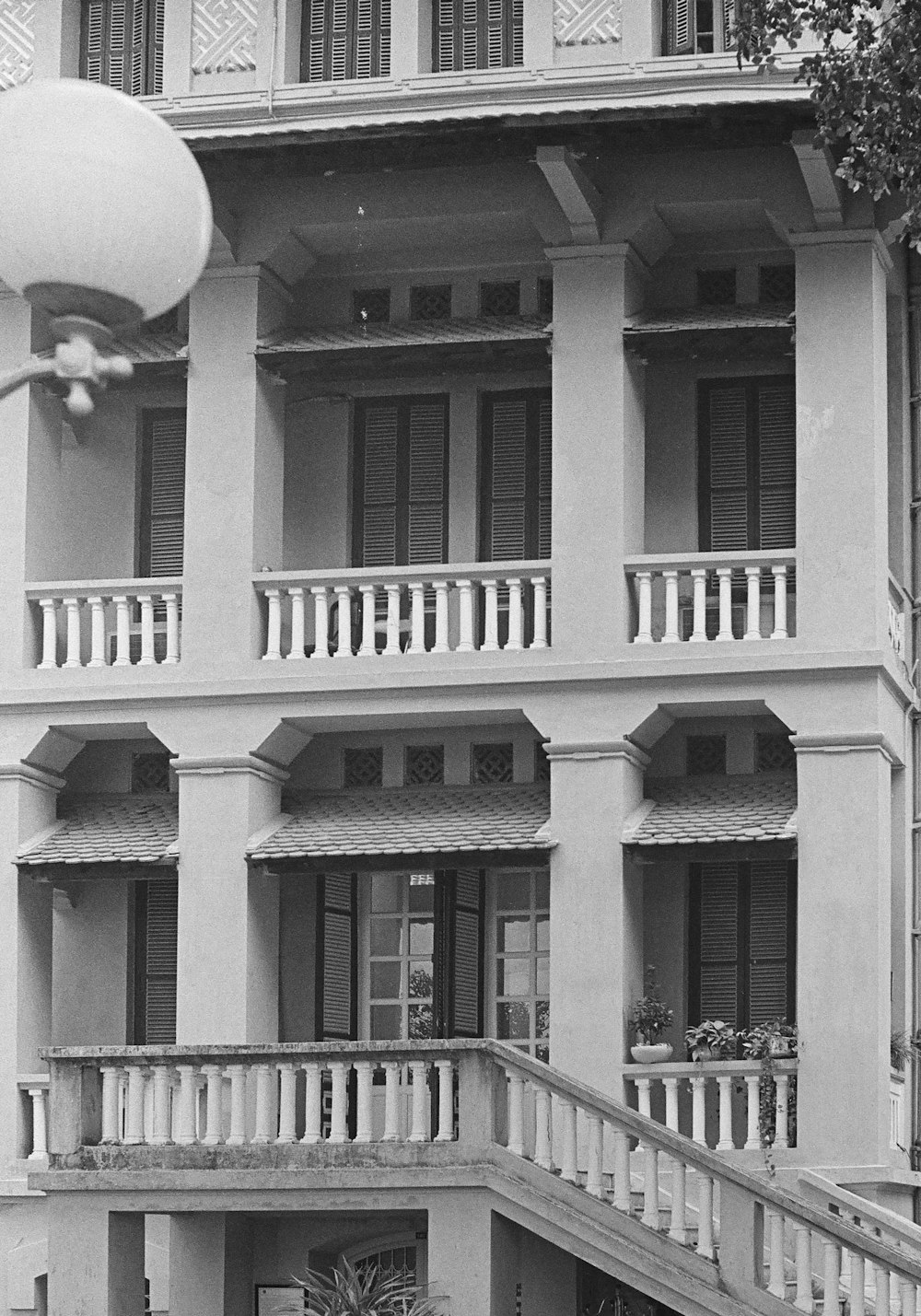 a black and white photo of a building with balconies