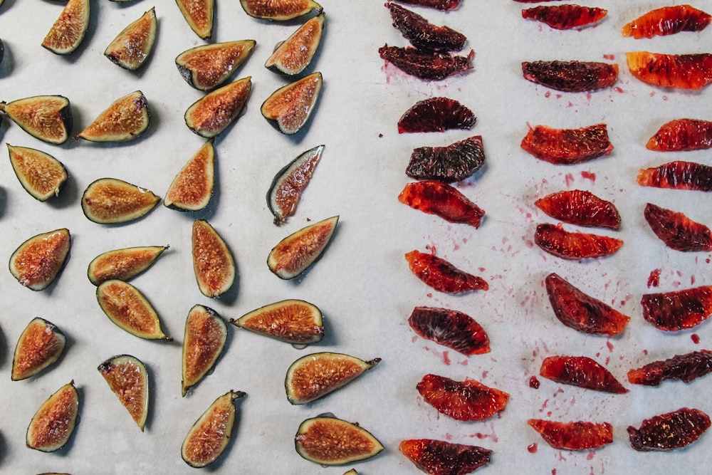 a table topped with sliced up figs next to another table