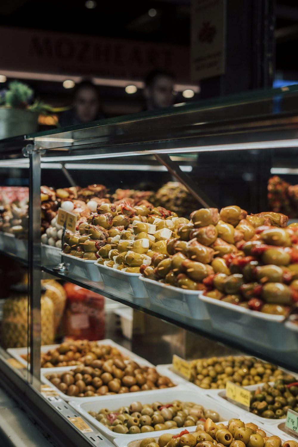 a display case in a grocery store filled with olives