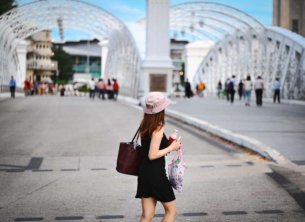 a woman in a pink hat is looking at her cell phone