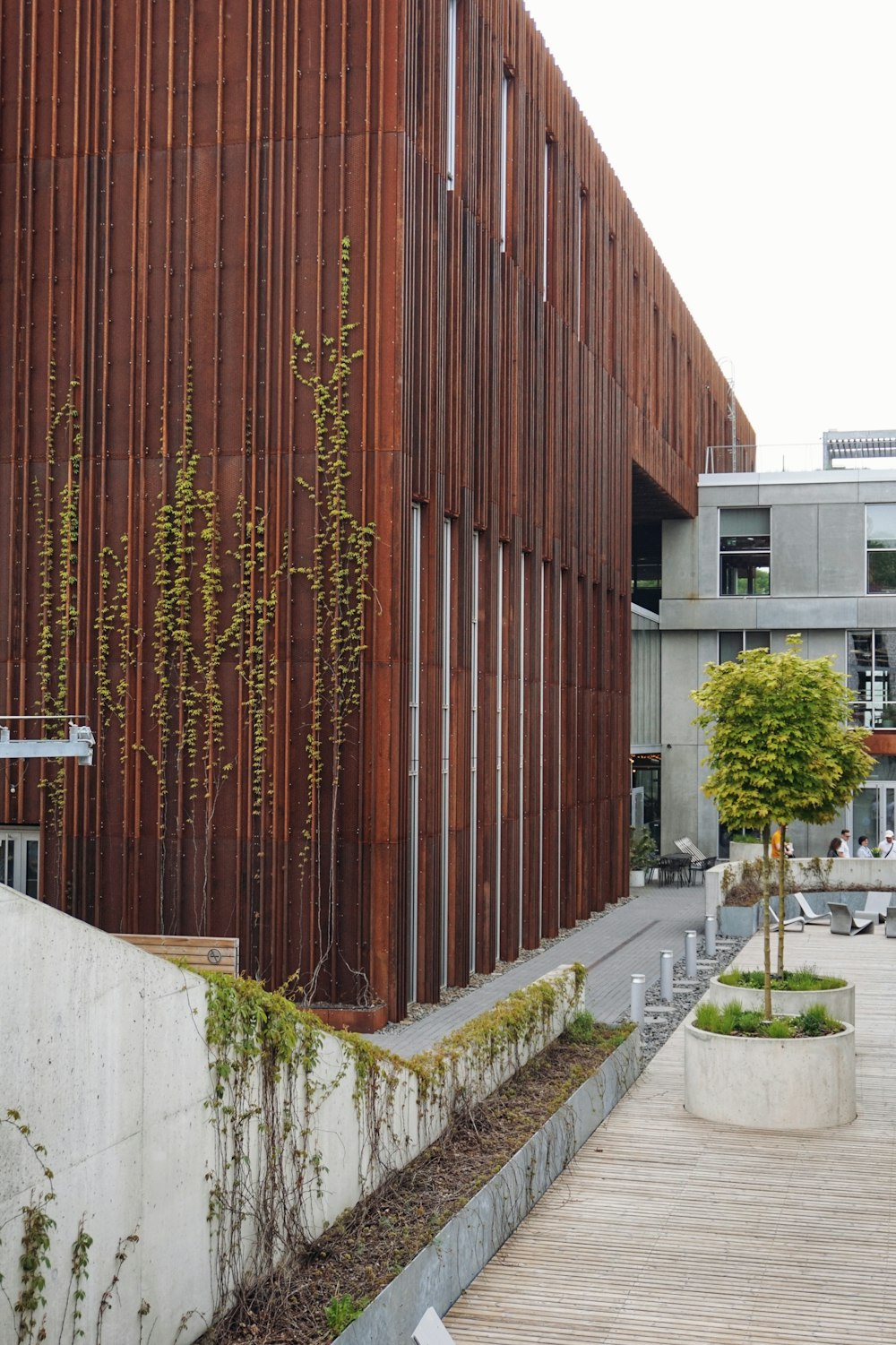 a building with a wooden facade and a wooden walkway