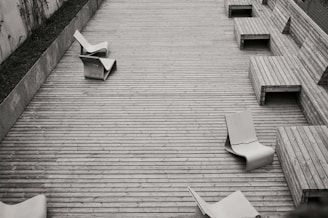 a black and white photo of some chairs and benches