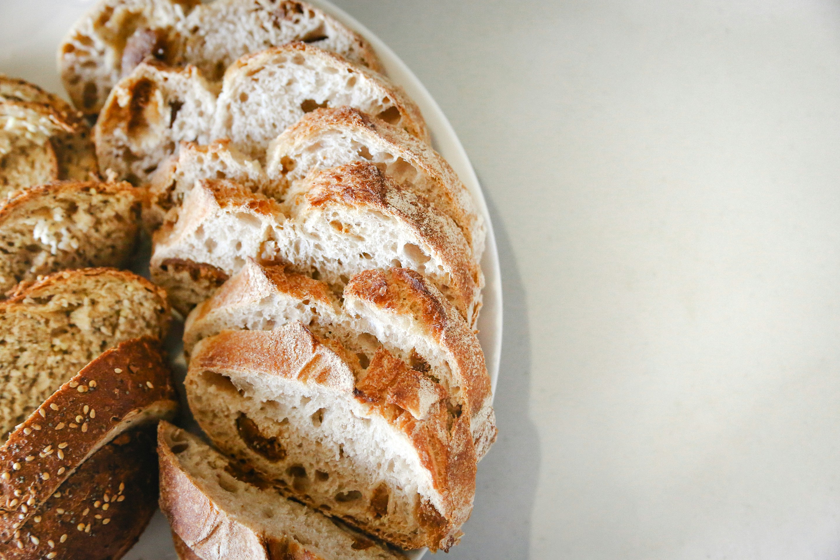 a white plate topped with sliced bread on top of a table