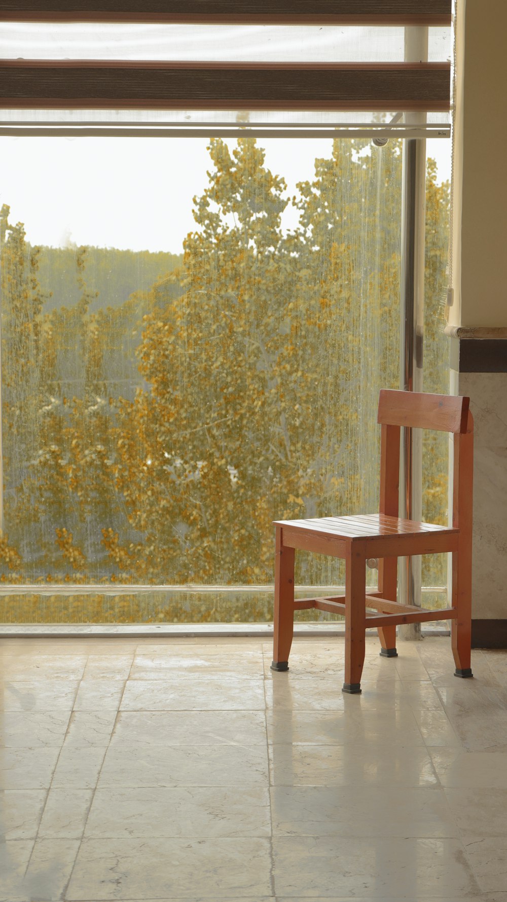a wooden chair sitting in front of a window