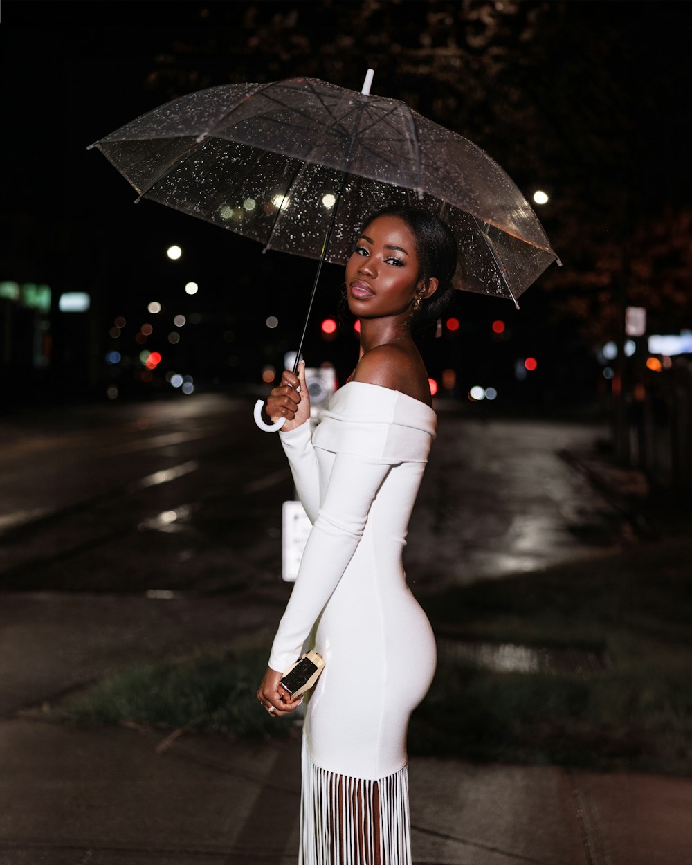 a woman in a white dress holding an umbrella