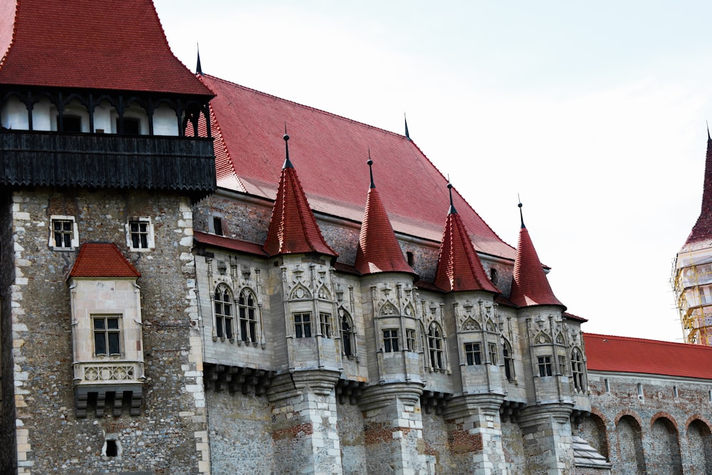 a large building with a red roof and a clock tower