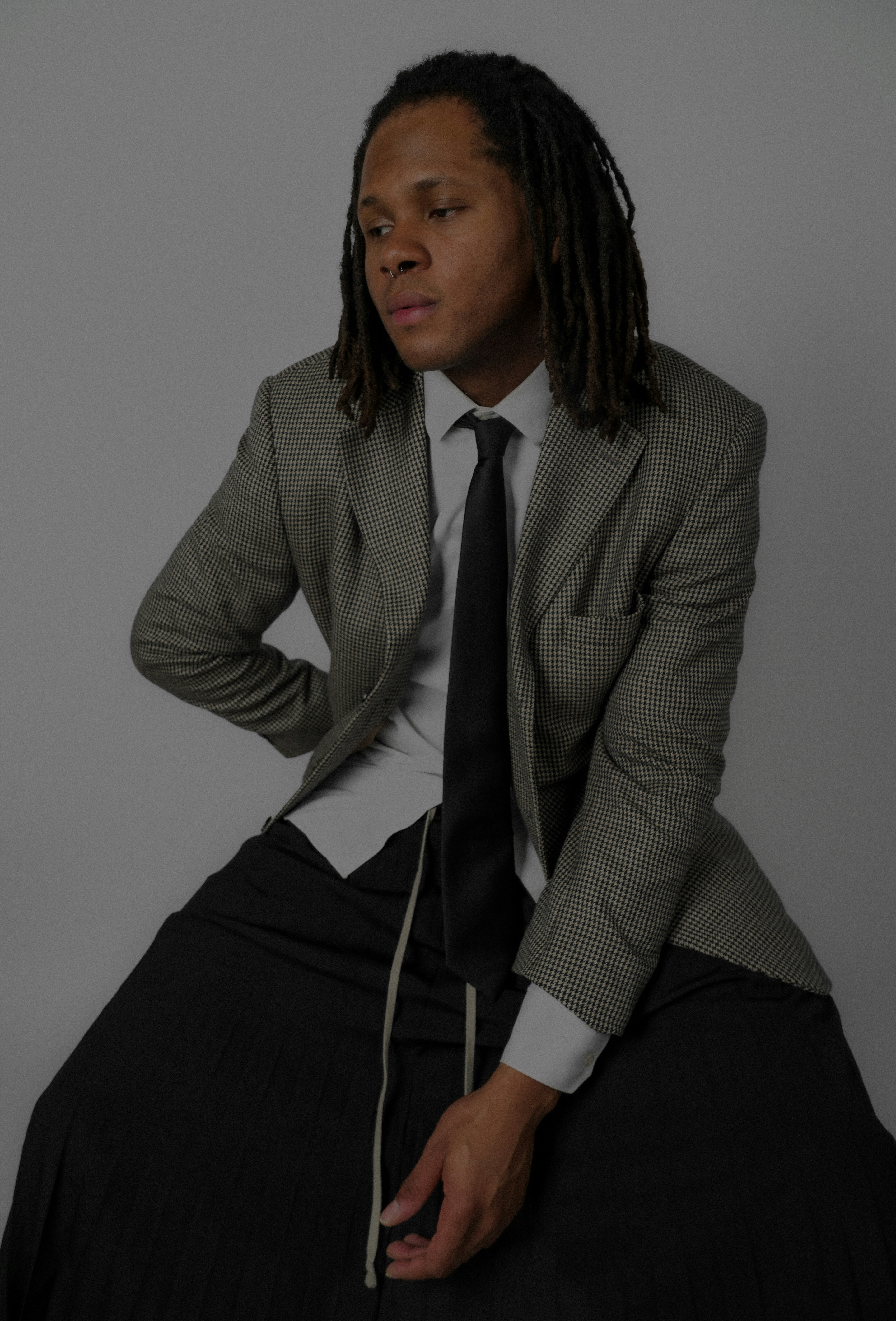 a man in a suit and tie sitting on a chair