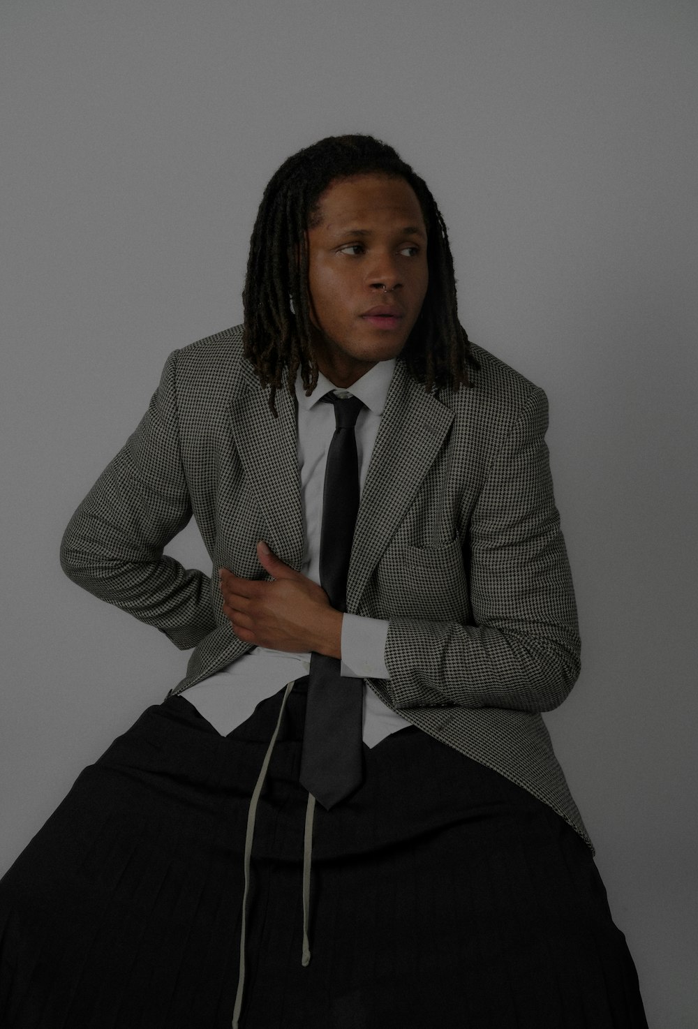 a man in a suit and tie sitting on a chair