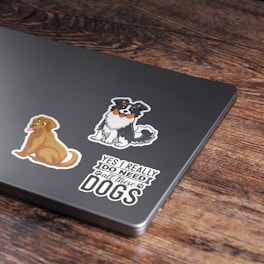 a laptop with stickers on it sitting on a table
