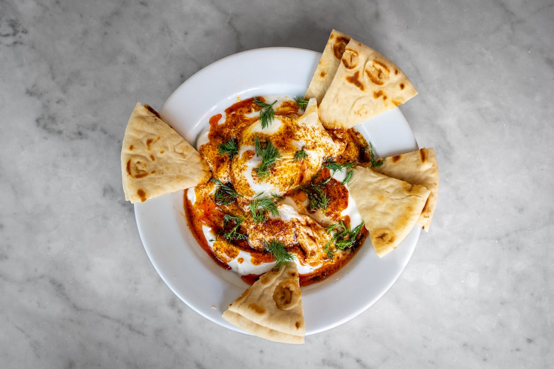 Çılbır is a Turkish breakfast dish of poached eggs and yogurt eaten with pita bread.