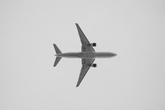 a large jetliner flying through a cloudy sky