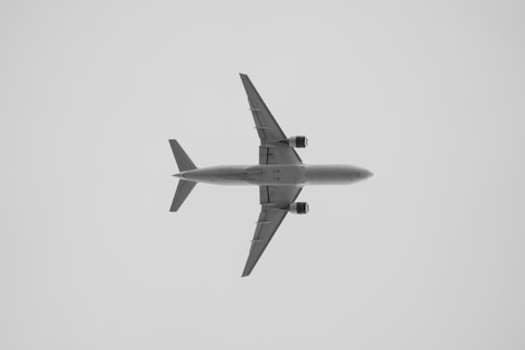 a large jetliner flying through a cloudy sky
