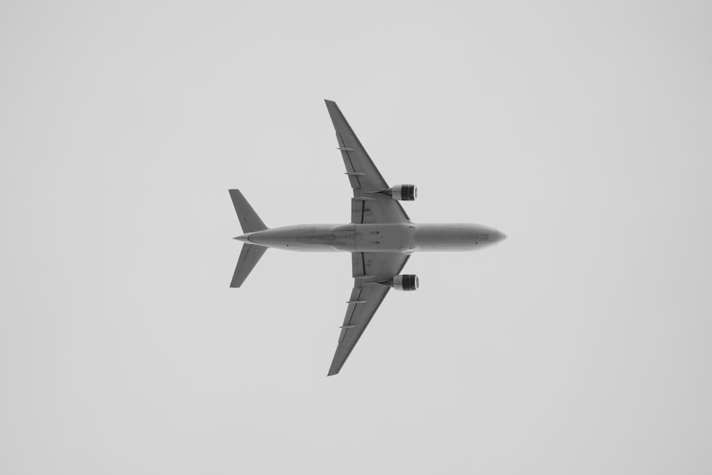 a large jetliner flying through a cloudy sky