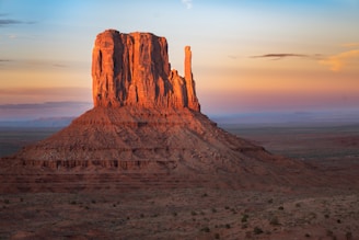 a large rock formation in the middle of a desert