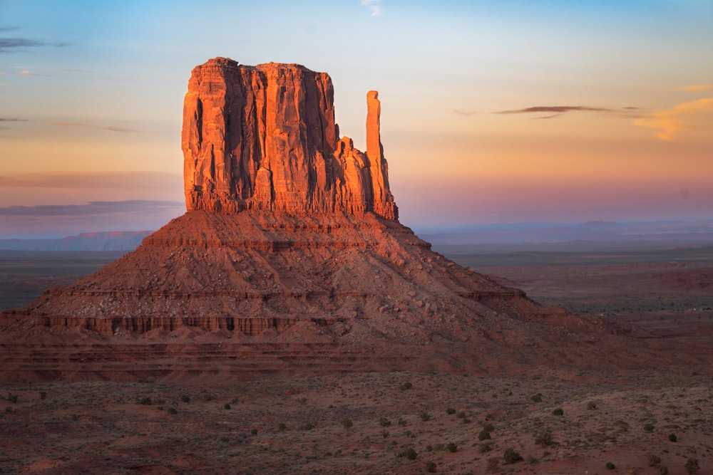 a large rock formation in the middle of a desert