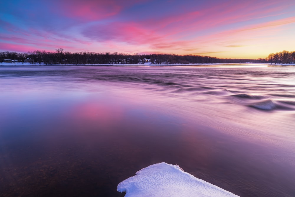 a beautiful sunset over a frozen lake