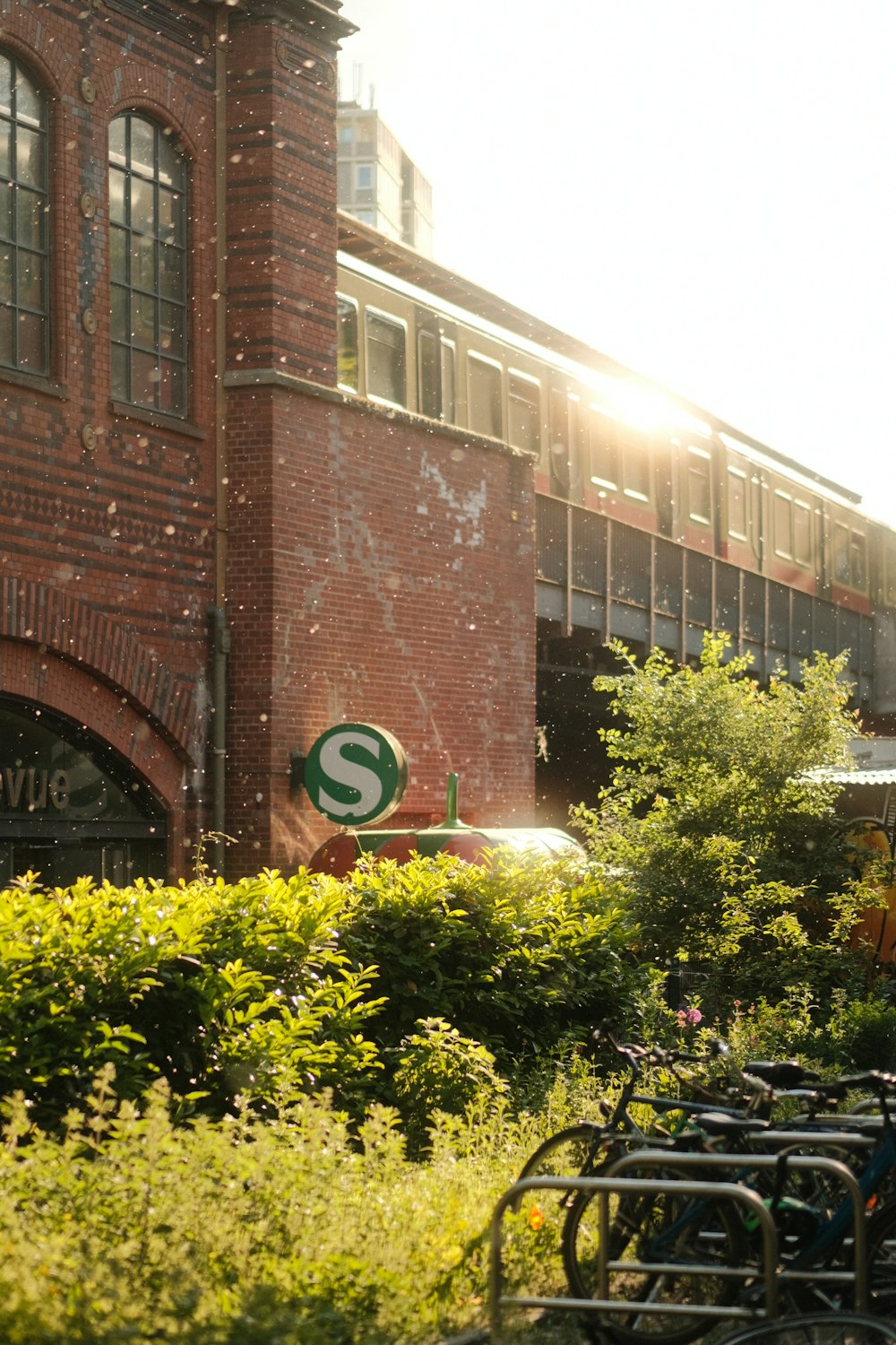 a train is passing by a brick building