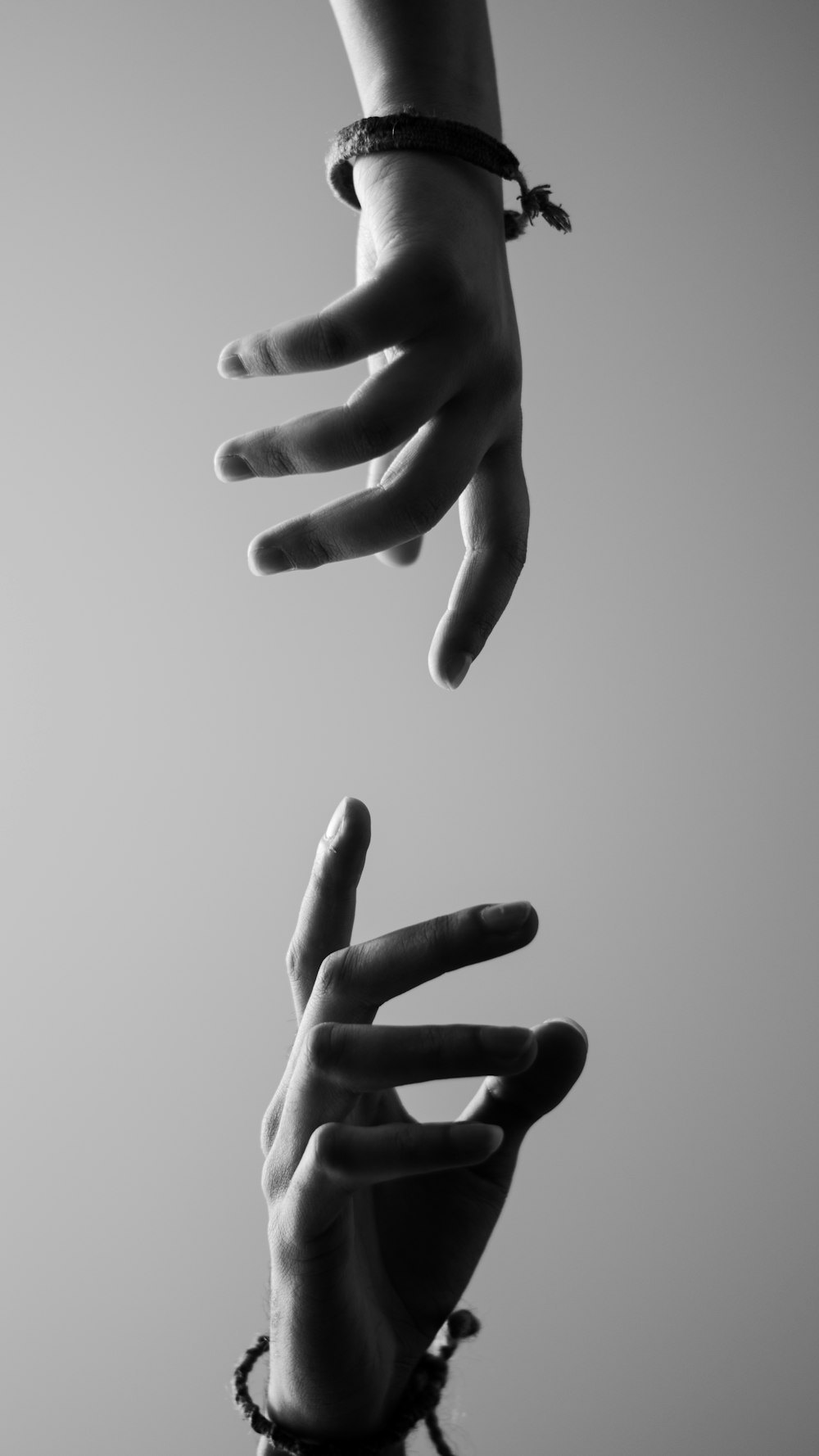 two hands reaching for each other in the air