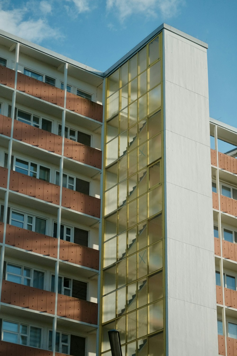 a tall building with a spiral staircase in front of it