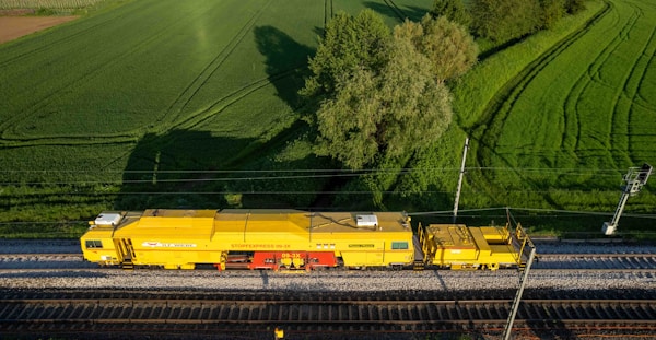 A regional train in green countryside representing battery-electric trains charged by Efacec stations in Denmark