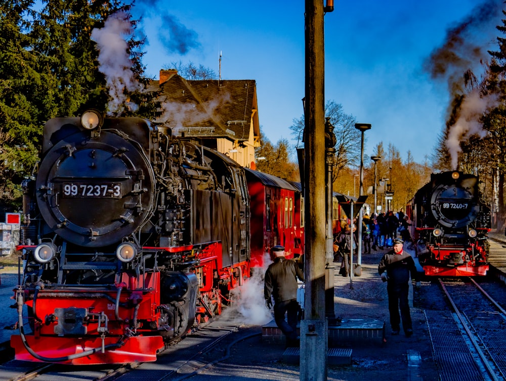 a steam engine train pulling into a train station