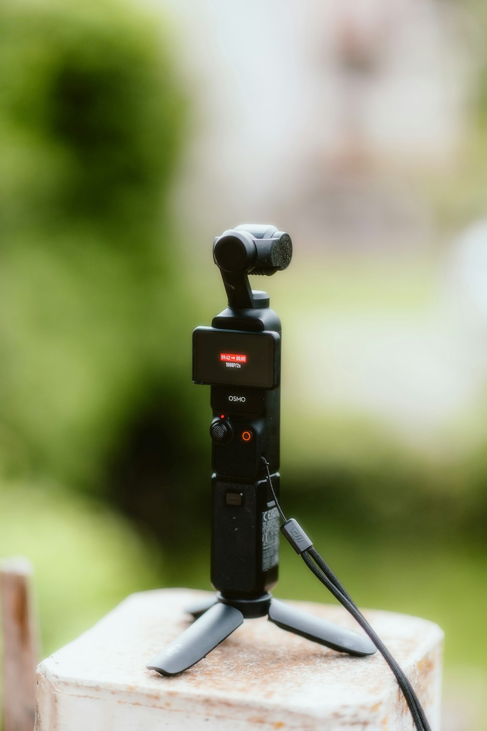 a camera attached to a tripod attached to a pole