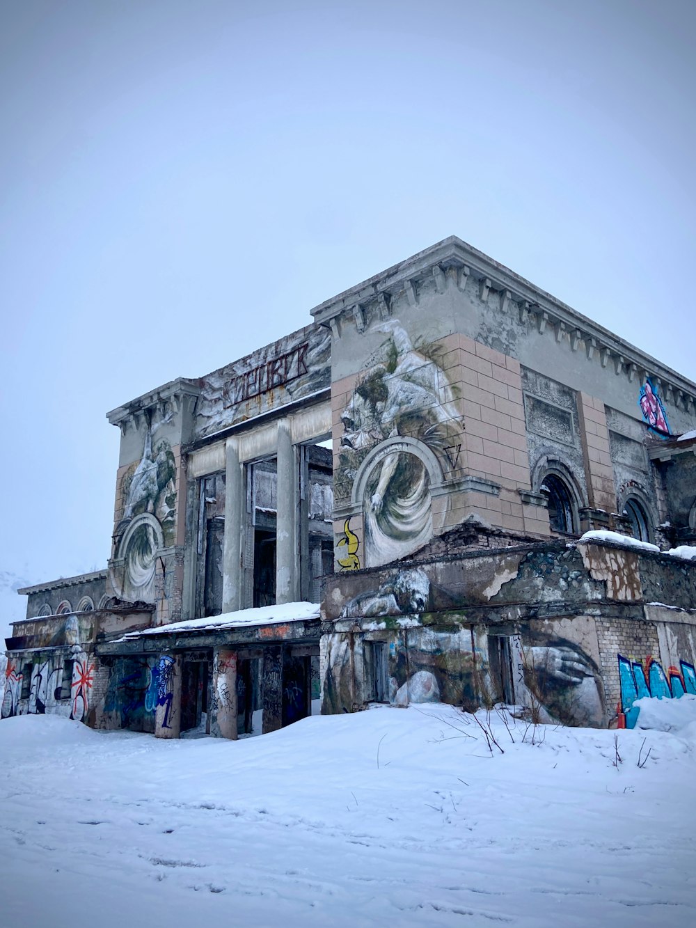 an old building with a lot of graffiti on it