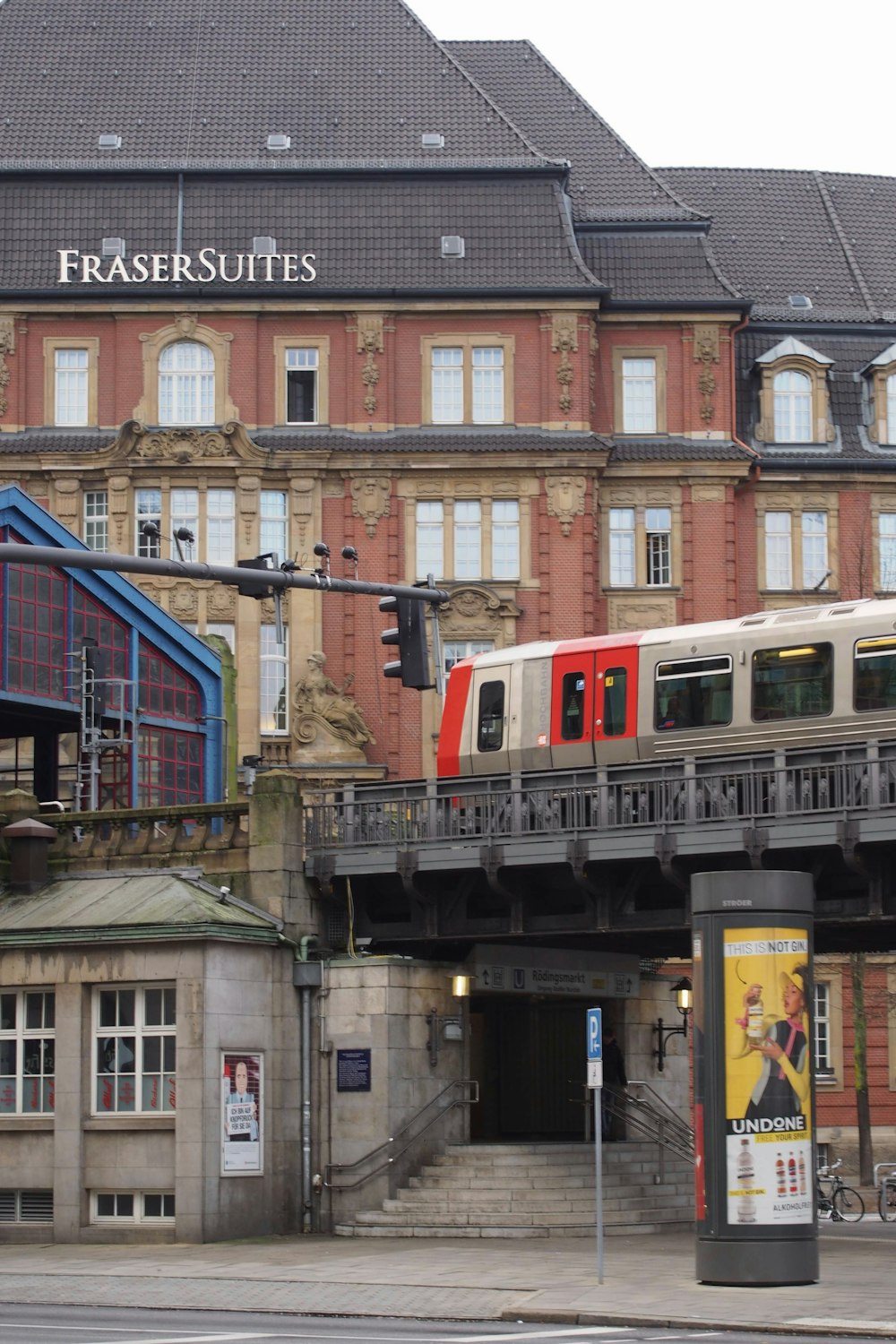 a train traveling over a bridge in front of a building