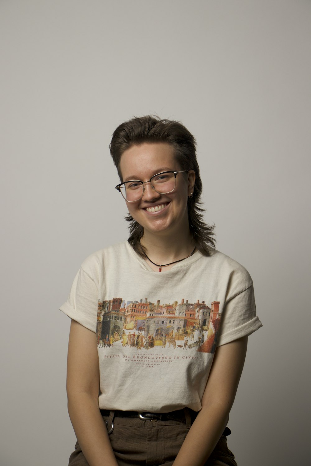 a woman with glasses is smiling for the camera