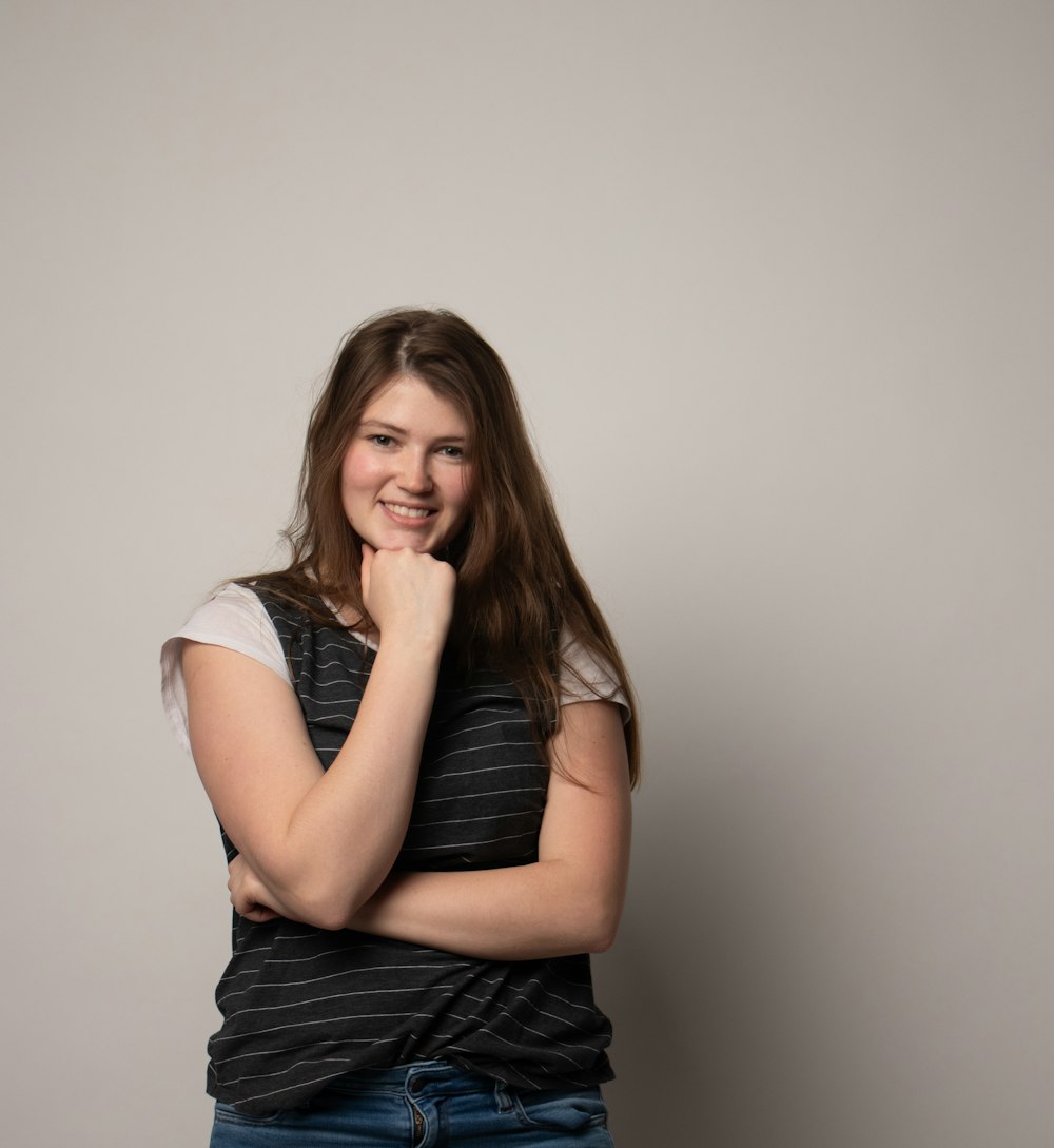 a woman posing for a picture with her hand on her chin